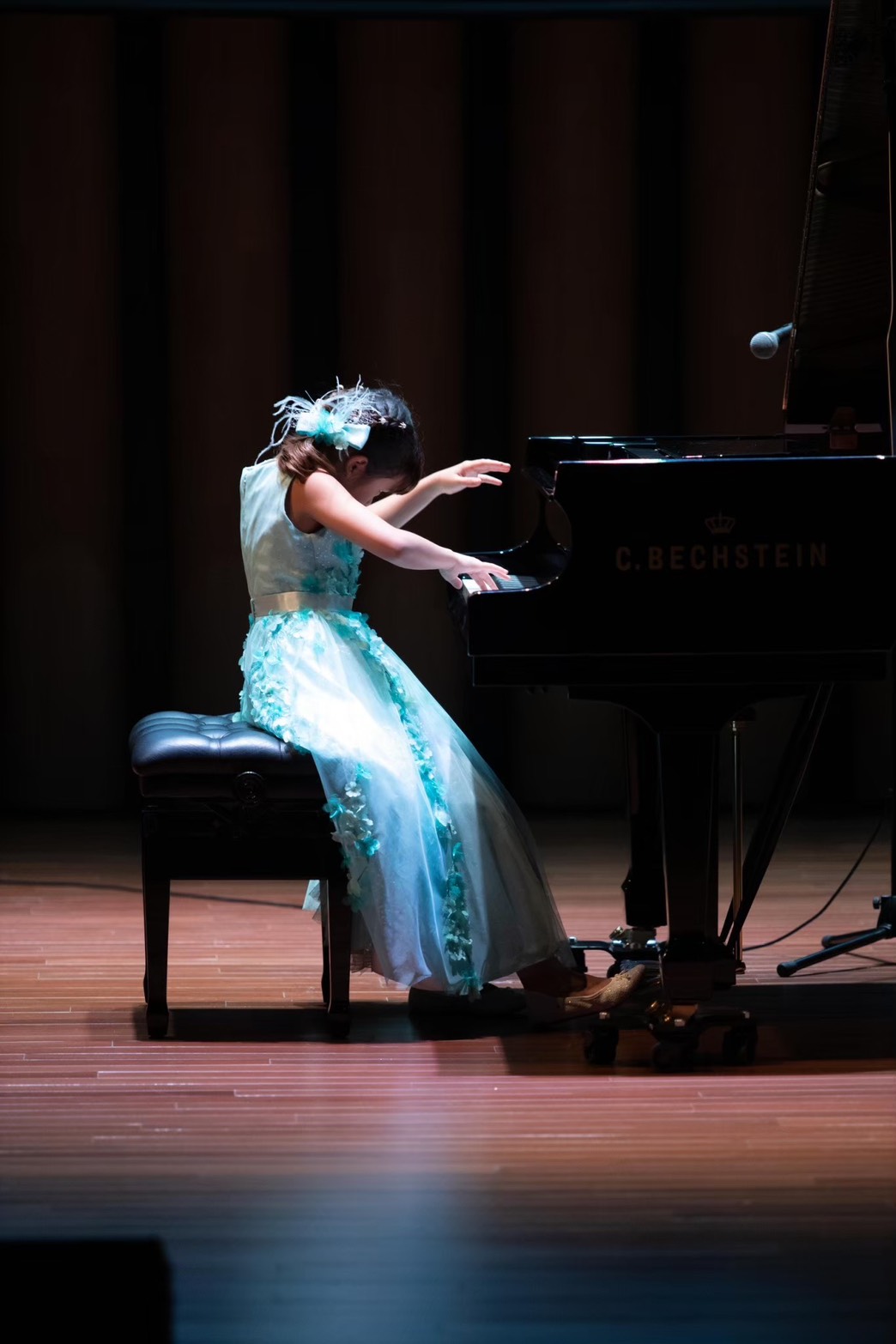 Annie performing piano on stage