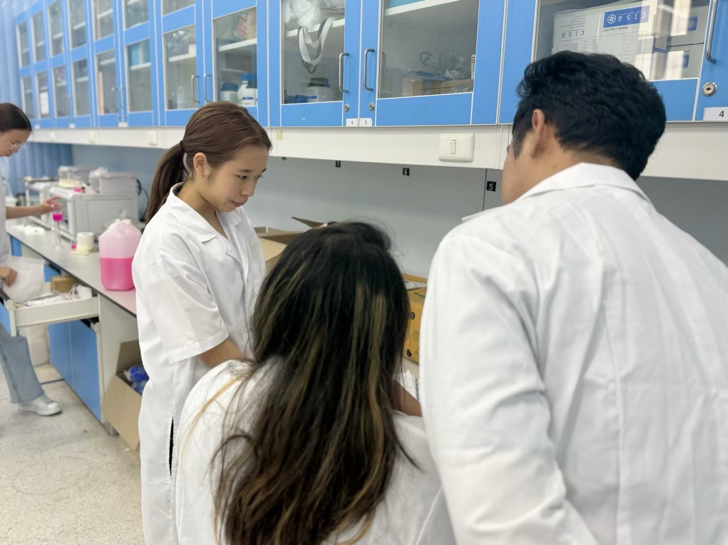 Annie observing a lab procedure with researchers