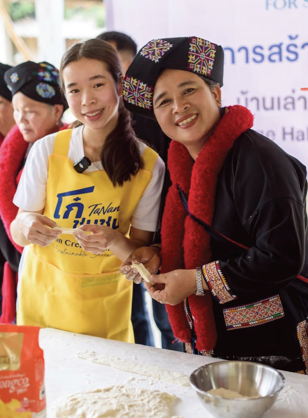 Annie wearing the TaNan apron with a community participant