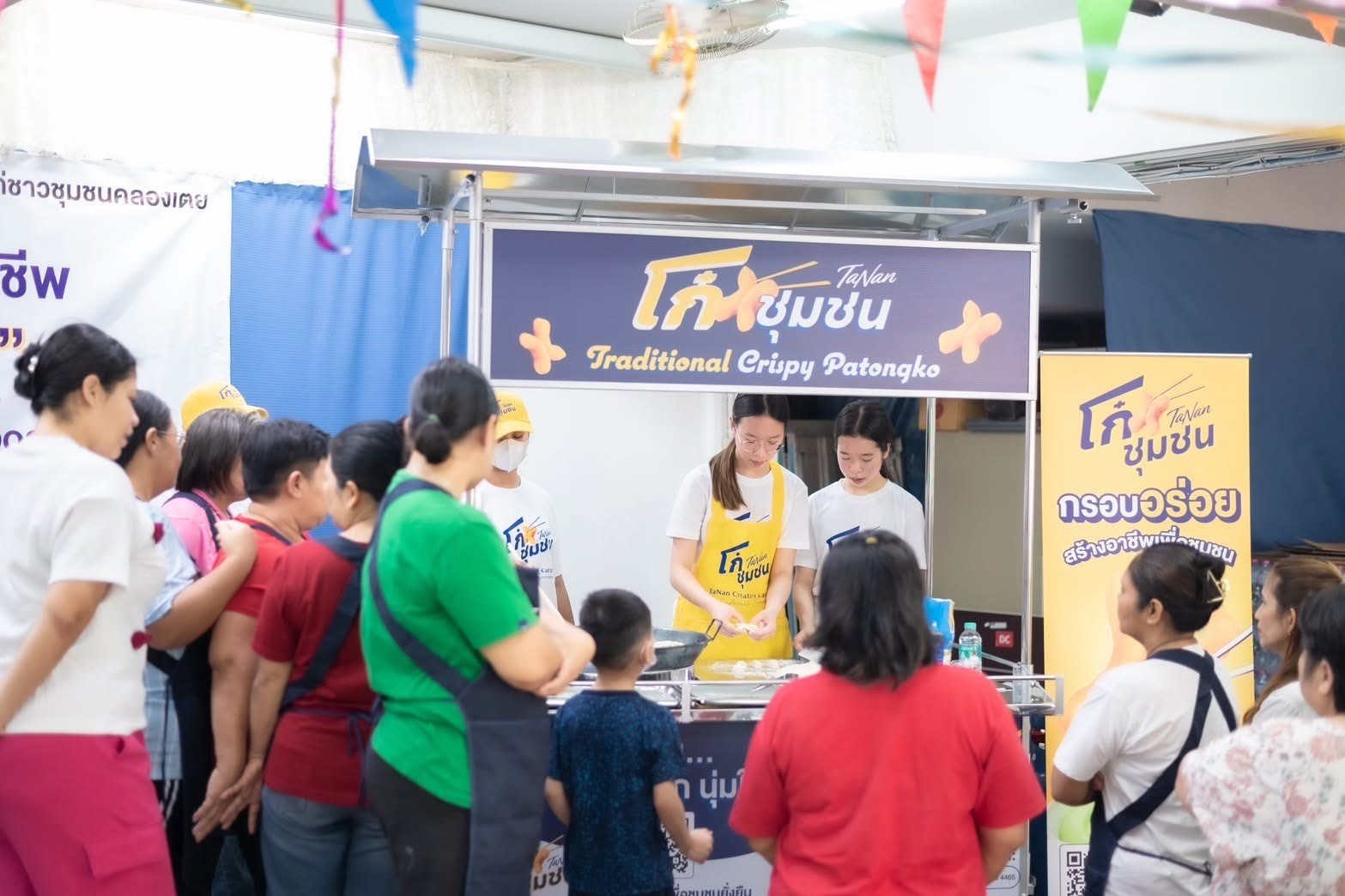 Annie demonstrating at the patongko food cart at Duang Prateep Foundation, Khlong Toei