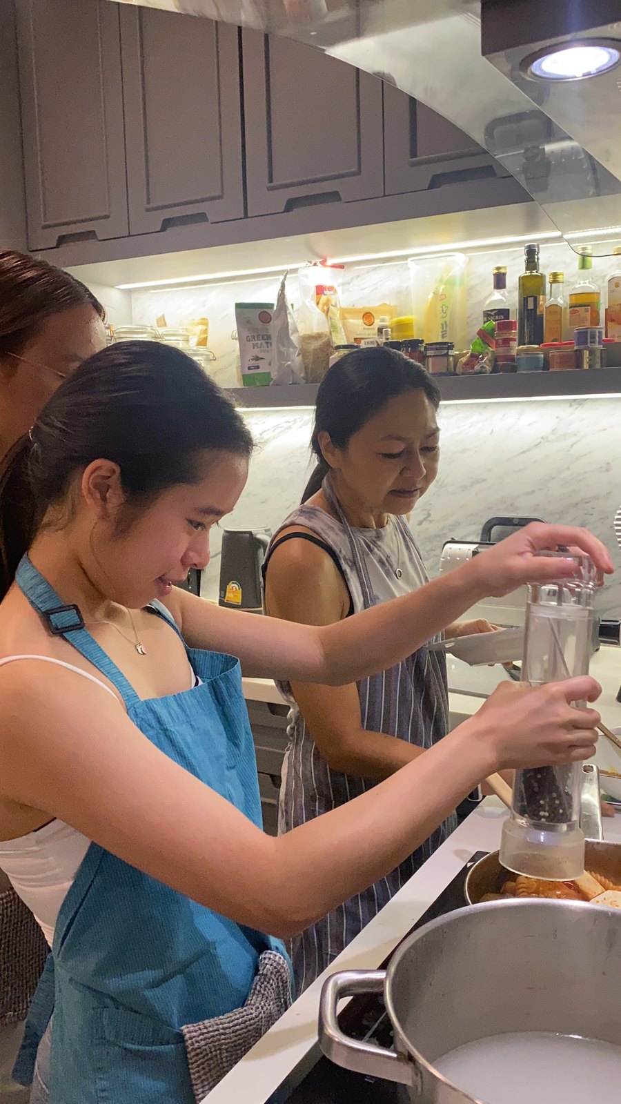 Annie seasoning a dish during a club cooking session